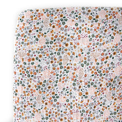 Little Unicorn Premium Crib Sheet with pressed petals on mattress for breathable softness.