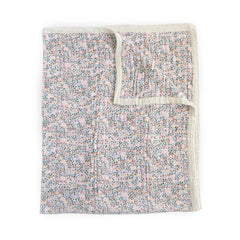 Little Unicorn Premium Quilted Throw close-up reveals four-layer muslin softness for cozy cuddles.