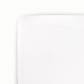 Little Unicorn stretch knit crib sheet in white, flat lay, highlighting softness and quality