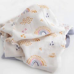 Little Unicorn Rainbows & Raindrops Deluxe Muslin Quilt in nursery decor setup showcases lightweight warmth