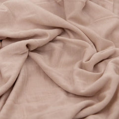 Little Unicorn stretch-knit swaddle with baby wrapped securely in place.