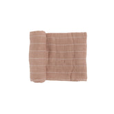 Little Unicorn Mauve Stripe swaddle closeup shows soft cotton muslin for newborn comfort.