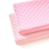Littogoose quilted changing table cover on pad offers snug fit and baby-friendly comfort.