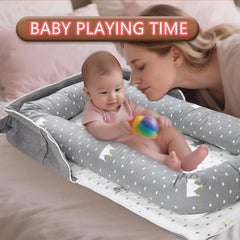 Loevin Crown Grey baby lounger in use on a portable mat for travel.