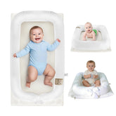Loevin portable baby lounger with white cover offers on-the-go comfort for newborns.