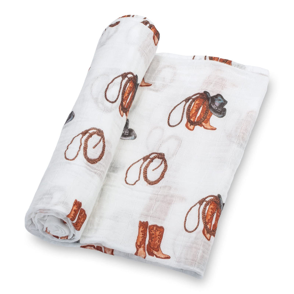 LollyBanks cowboy boot print swaddle closeup showing playful pattern and fabric texture