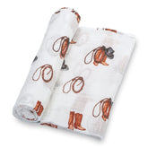 LollyBanks cowboy boot print swaddle closeup showing playful pattern and fabric texture