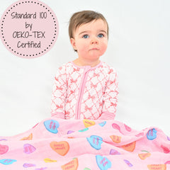 LollyBanks heart print swaddle used as a practical burp cloth.