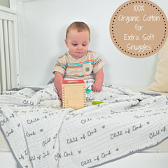 LollyBanks muslin blanket being held by toddler for cozy cuddles.