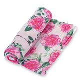 LollyBanks Peony Print swaddle blanket seen draped over a crib, breathable and cozy.