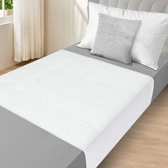 LotuFlor bed pad with tuckable wings keeps protection in place overnight.