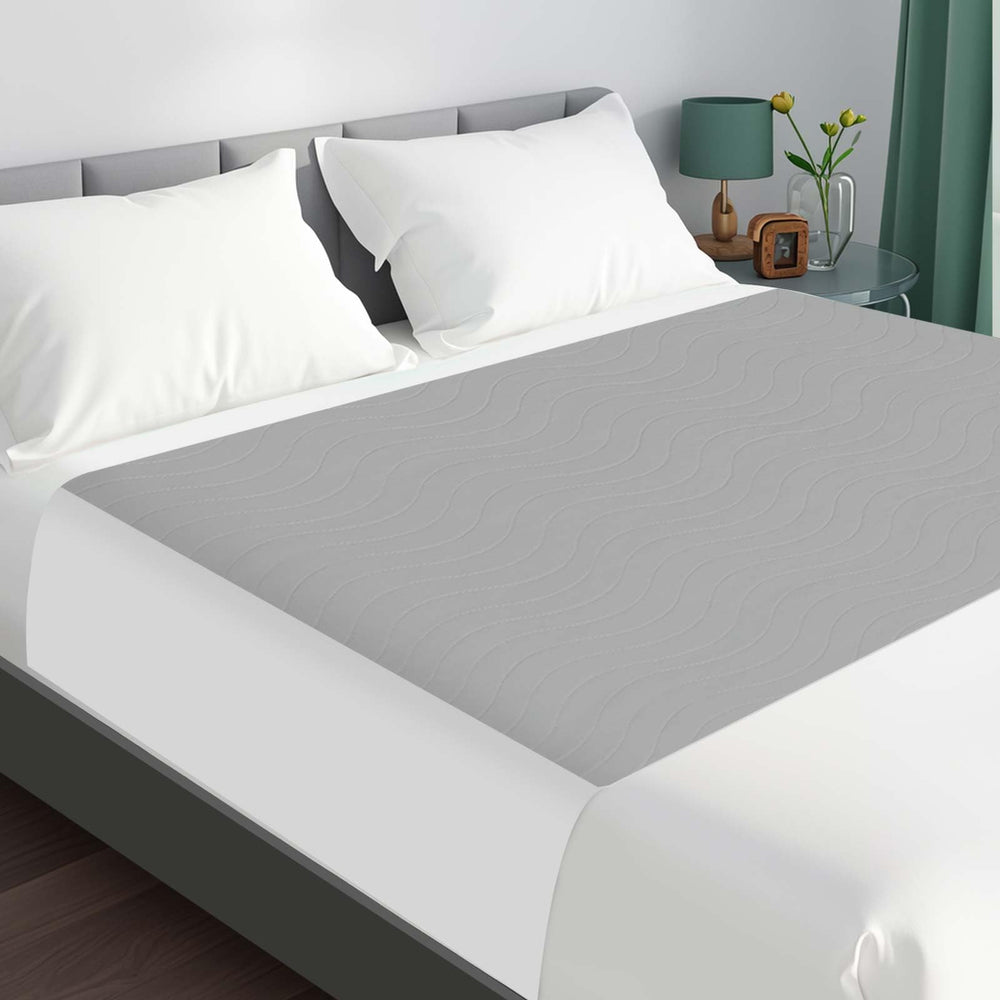 LotuFlor king-size bed pad with waterproof top layer protects mattress overnight