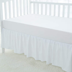 Love2Sleep dust ruffle on mini crib demonstrates secure fit and elegant white finish