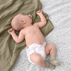 Lulumoon olive muslin blanket on crib for year round warmth