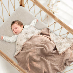 Lulumoon muslin blanket Sand Daisy draped over crib for cozy warmth and skin-friendly feel