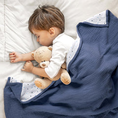 Lulumoon muslin blanket attached to stroller as sun shield for outdoor trips