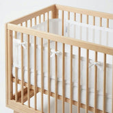 Luvberries breathable mesh crib liner for airflow and arm protection in standard cribs.