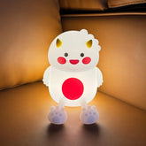 Lwalaneng dinosaur night light in breastfeeding setup for hands-free visibility