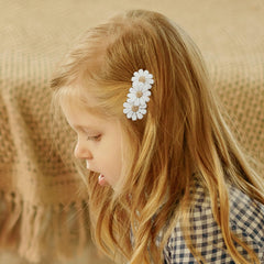 Minimalist color palette clips complement outfits from onesies to party dresses.
