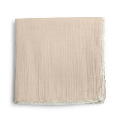 MakeMake Organics muslin blanket close-up texture showing breathable organic cotton for baby comfort.