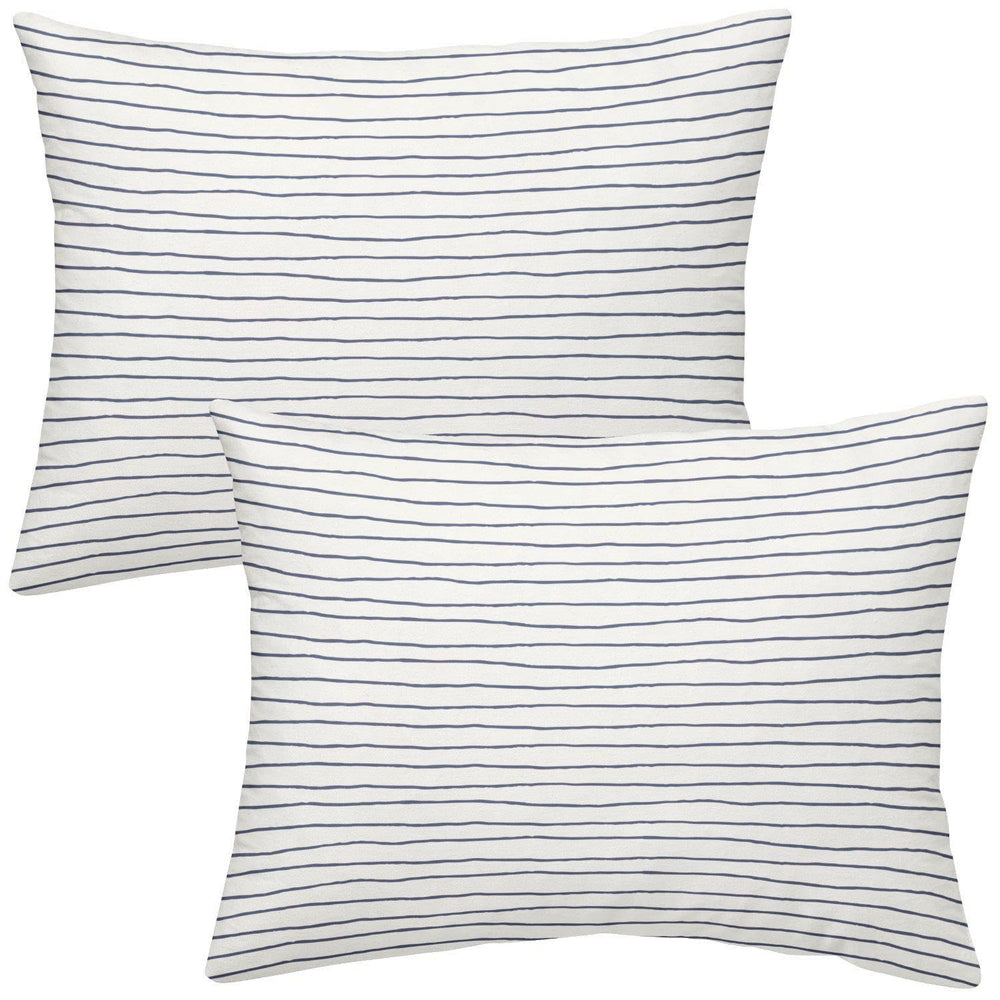 Makemake Organics toddler pillowcase navy stripes closeup with breathable cotton sateen texture.