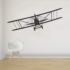 Makeyes Biplane wall decal on a bedroom wall adds aviation charm.
