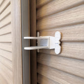 Makibi sliding door lock close-up illustrates secure adhesion for child safety
