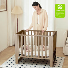 Mamazing EvoNest crib with wheels demonstrated for easy room-to-room movement.