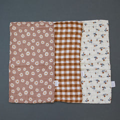 Mebie Baby burp cloths close-up on soft muslin for gentle touch.
