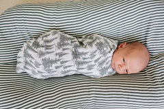 Mebie Baby forest neutral design fits modern nurseries and versatile wrapping.