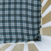 Mebie Baby navy plaid muslin sheet closeup showing soft, breathable fabric for comfy baby sleep