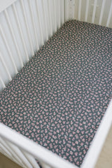 Close-up of Mebie Baby Olive Bloom muslin sheet showing soft texture.