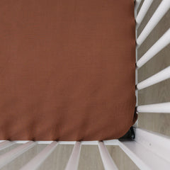 Mebie Baby stretch sheet rust close-up showing soft elastic fabric for a snug fit.