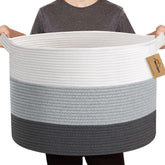 MEGASKET extra large cotton rope basket for blanket storage in a cozy living room.