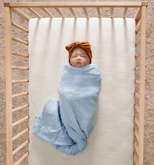 Meracorallo muslin crib sheet cream closeup fabric texture highlighting softness