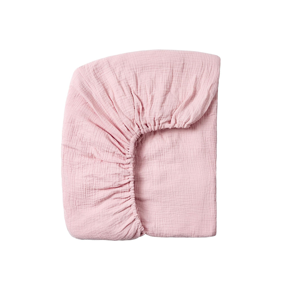 Meracorallo muslin crib sheet pink close-up fabric shows breathable cotton softness.