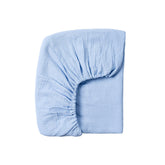 Meracorallo muslin crib sheet sky blue folded for soft, breathable comfort.