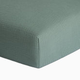 Meracorallo Roman Green muslin crib sheet close-up shows soft, breathable texture
