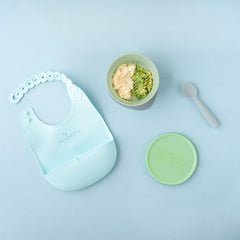 Miniware silicone bib ready to catch mess with Roll & Lock design