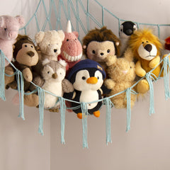 Mirolam toy storage net hangs neatly saving floor space in a kid's room