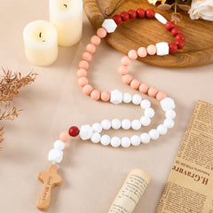 Misdary Baby Rosary in dark pink square packaging contents, a sentimental baptism keepsake