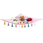 Mkono pink tassel stuffed animal hammock mounted in corner to save space