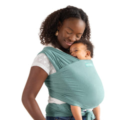 Moby Element Hydro wrap hip carry, showing hands-free versatility for parents on the go.