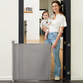 Momcozy Auto Lock Retractable Gate in doorway, safe for babies and pets.