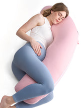 Momcozy body pillow in J-shape on bed for full-night support
