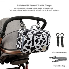MOMIGO cow print diaper caddy with durable hand strap for daily use.