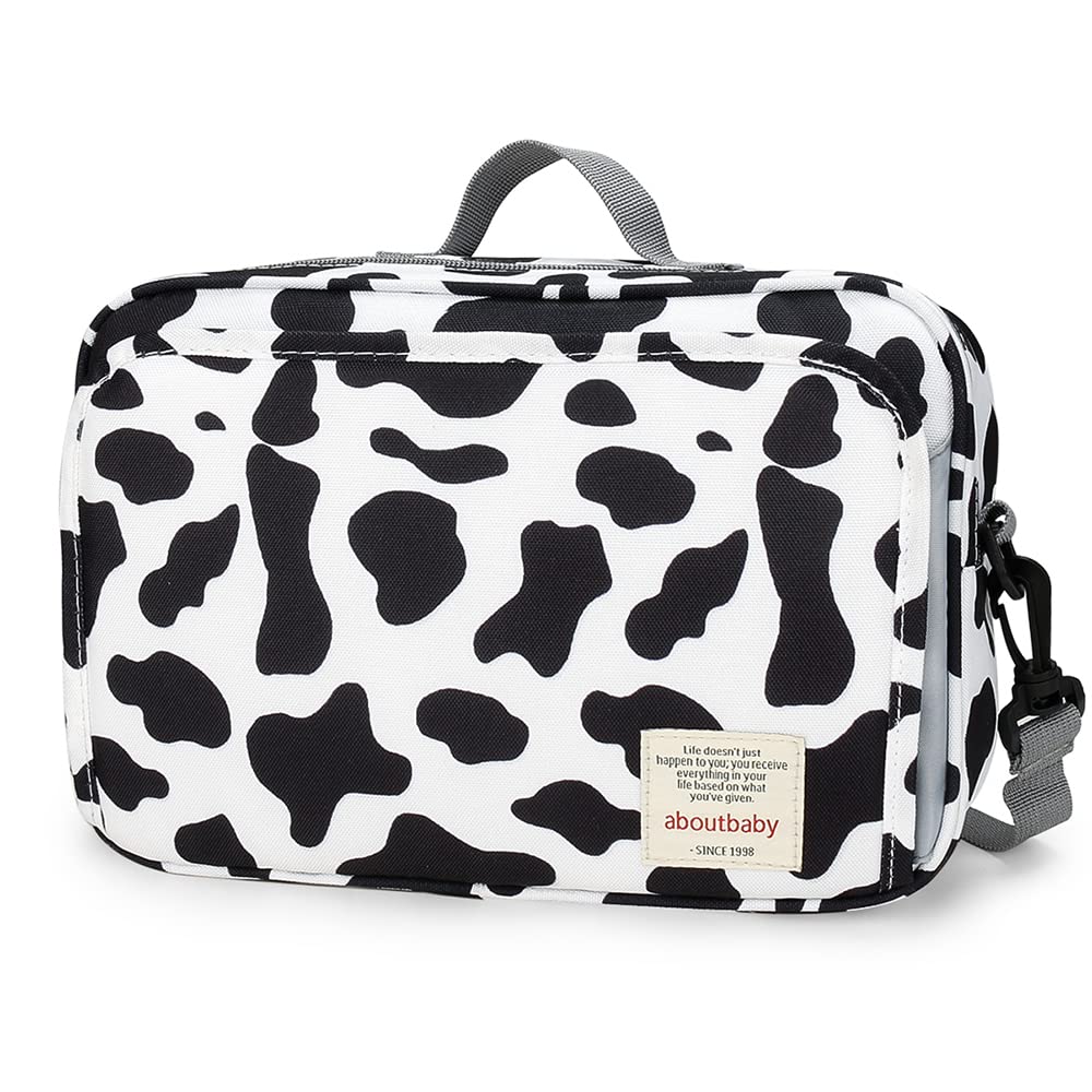 MOMIGO cow print diaper caddy with multi pocket design for easy travel organization.