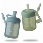 Moonkie Baby straw cup with lid on for spill-free practice during transitions.