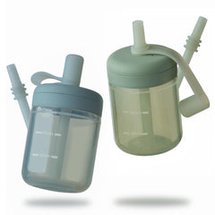 Moonkie Baby straw cup with lid on for spill-free practice during transitions.