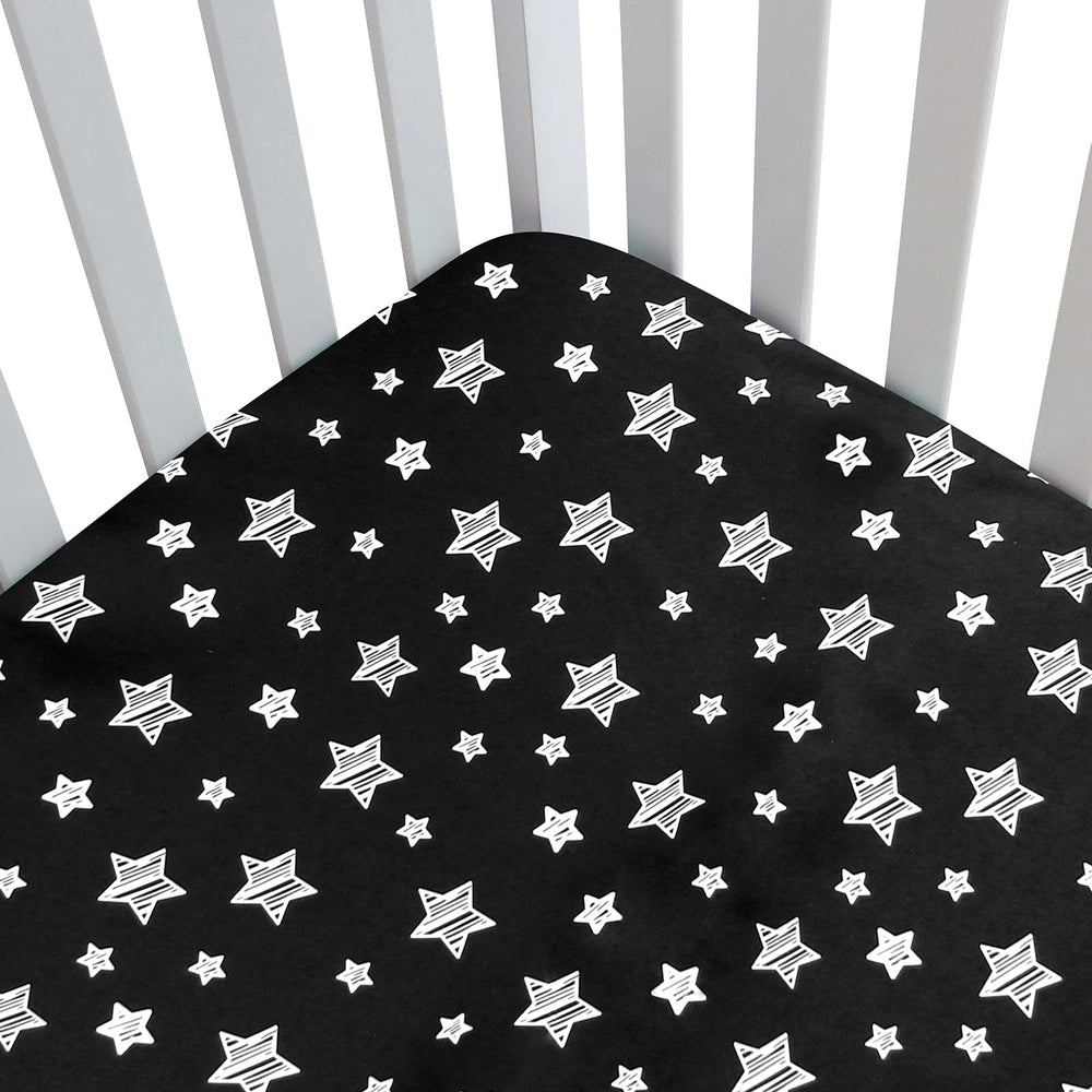 Moonsea Black Star crib sheet side view demonstrates snug fit for a standard crib